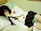 Kinky Asian girl in fancy mask lies in bed and rubs her clit with vibrator