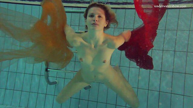 Pretty hot red head Nastya is stripping under the water